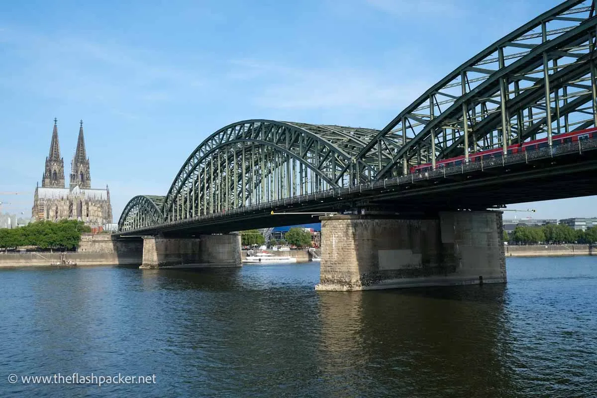 Solo Travel in Europe: The Best Places to Go Alone (2026) 17 iron railway bridge over river with cologne cathedral in background